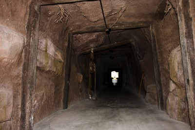 photo of old mine shaft with light at the end